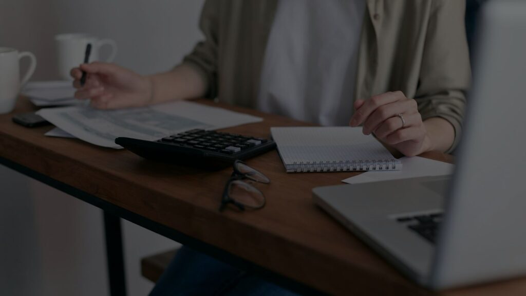 a photo of a business owner calculating her tax