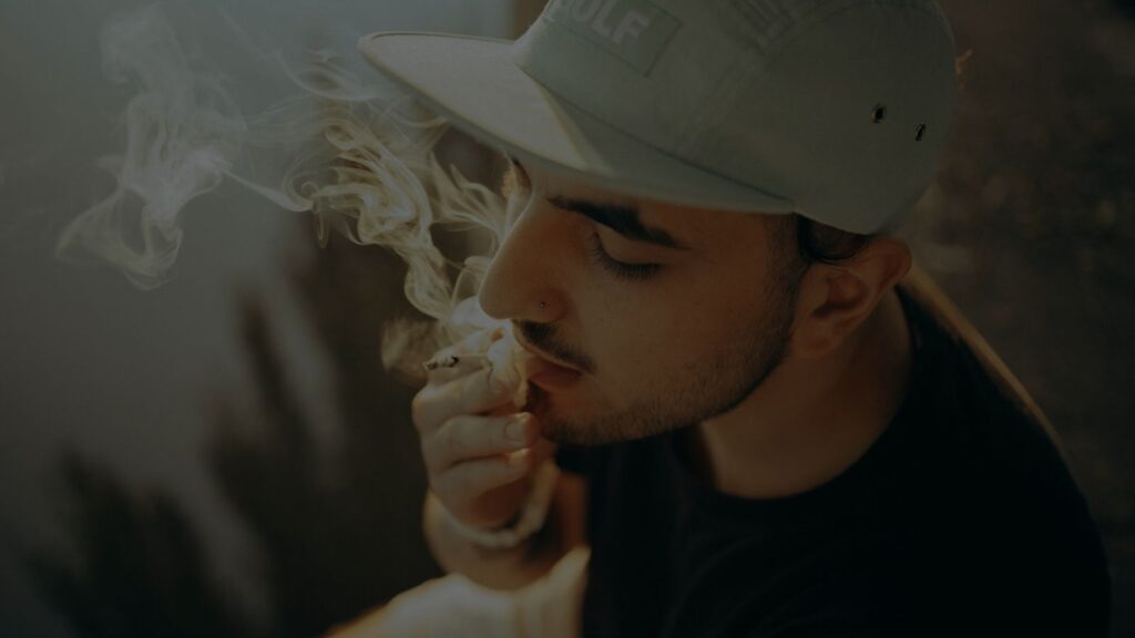 a photo of a man hitting his cigarette