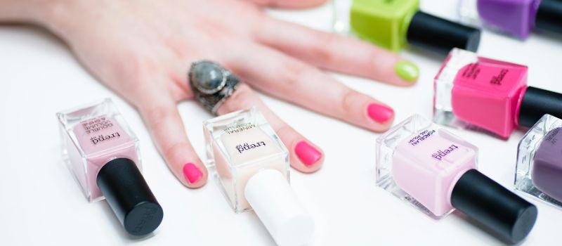 a hand with a manicure and nail polish