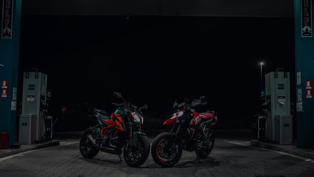 a photo of 2 motorcyle in a gas station