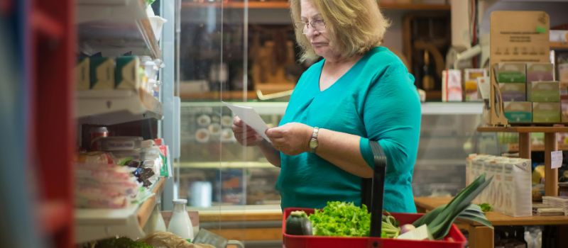 a person buying fresh veggies in the market