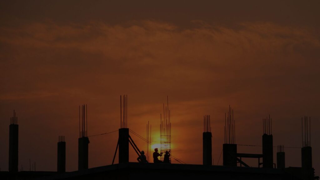 a photo of on going construction under sunset