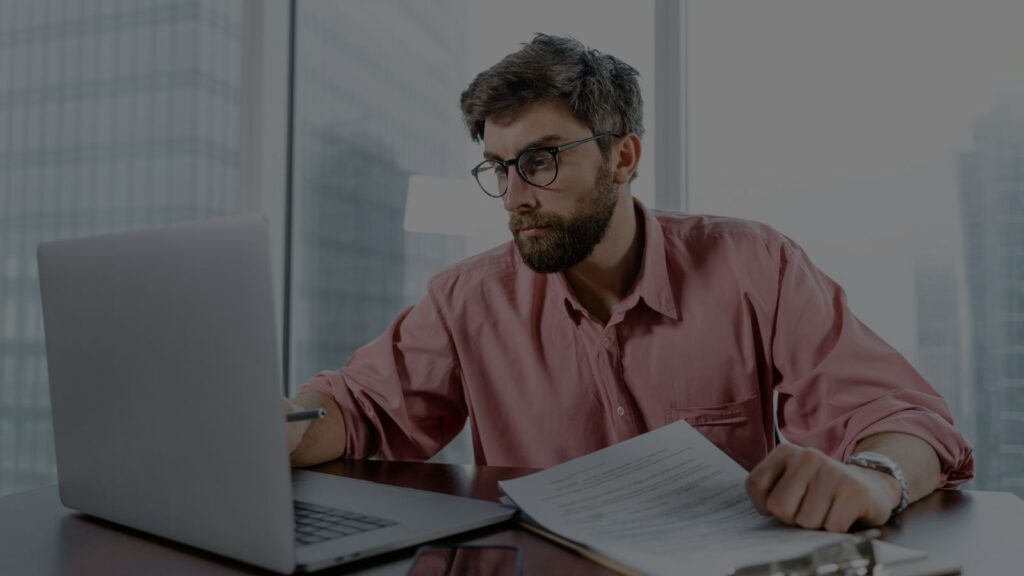 a photo of man analyzing the documents