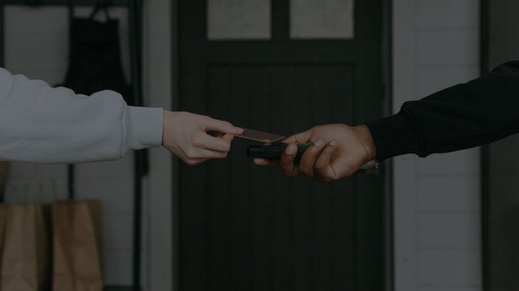 a photo of a shopper paying with atm