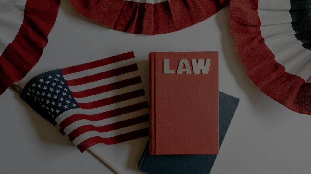 a photo of a lawbook and US flag