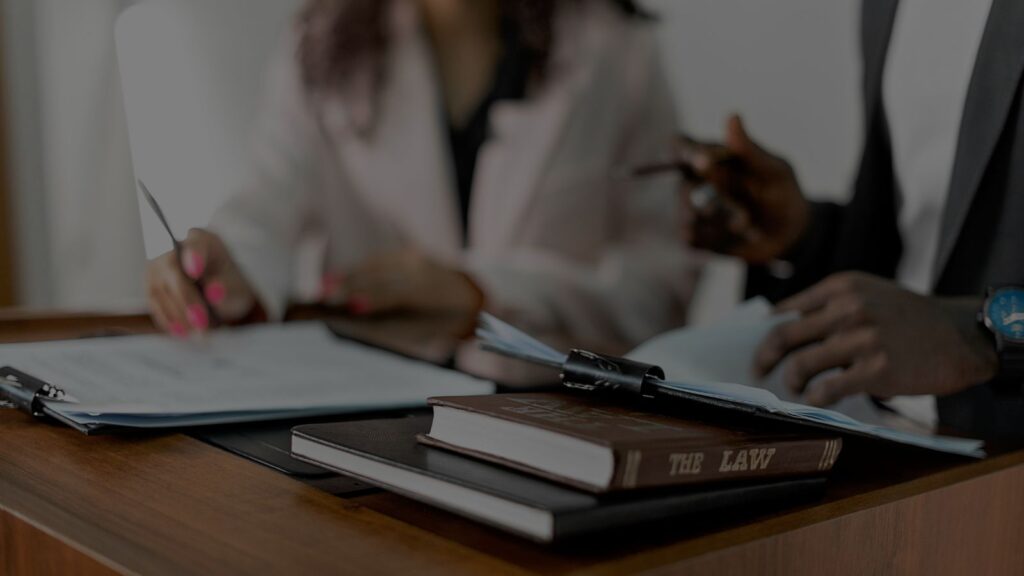 a photo of lawyer talking to his client