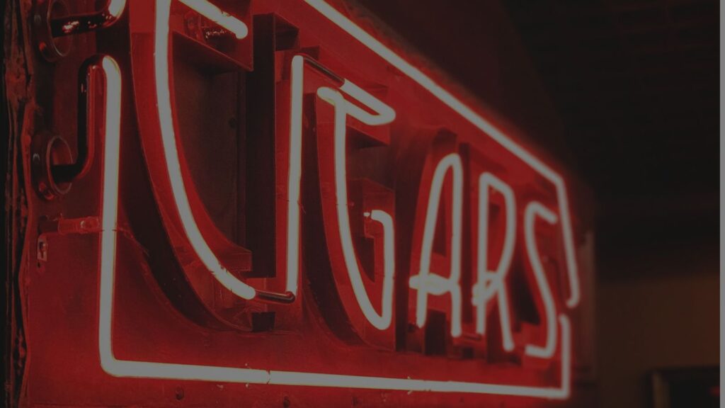 a photo of a signage that has a cigar on it