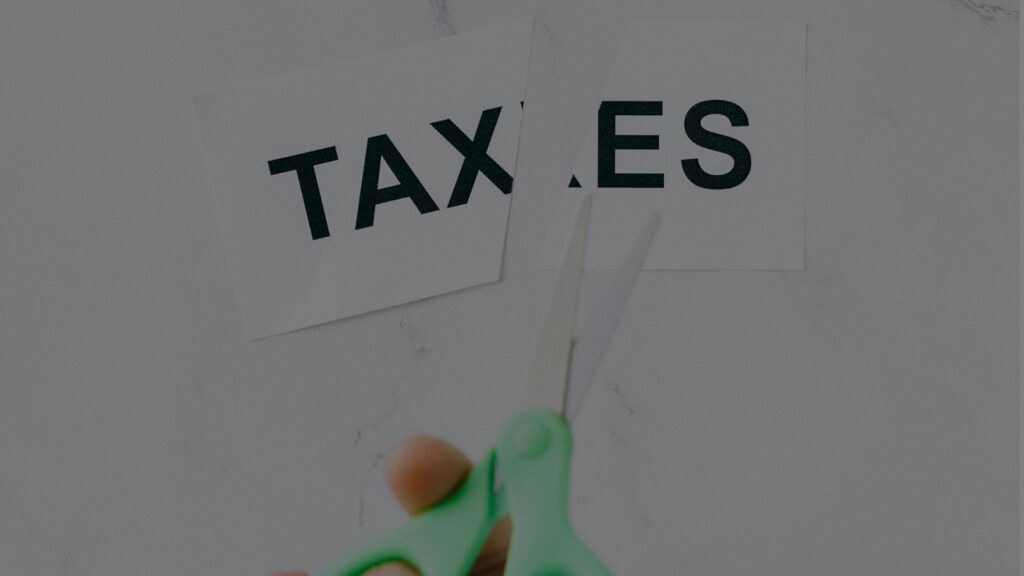 a paper with tax word cut by scissor