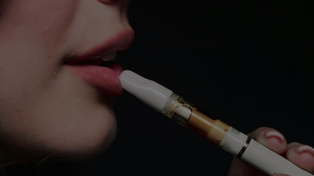 a woman hitting her vape