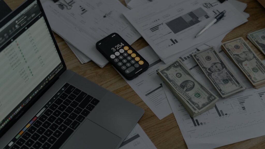 a photo of money, calculator and all the documents