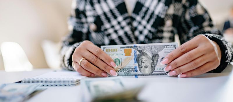 woman holding a dollar