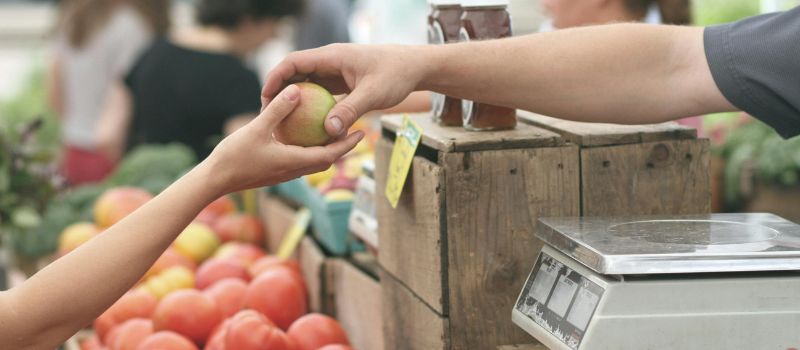 a photo of 2 person holding a fruit