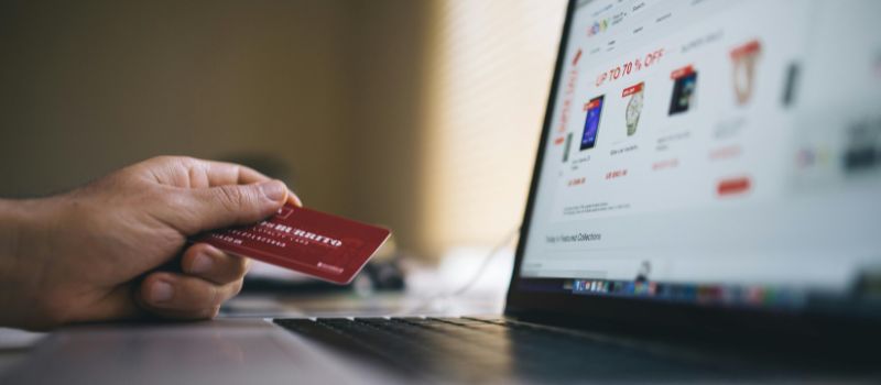 man holding atm while purchasing a discount
