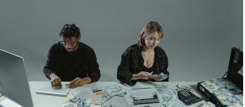 two people counting money