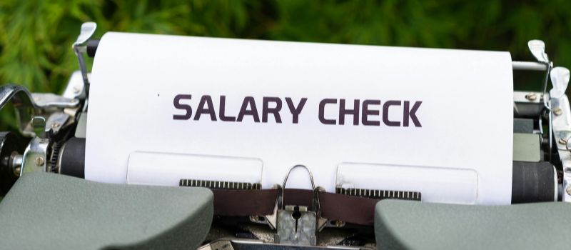 machine with a salary check written on it