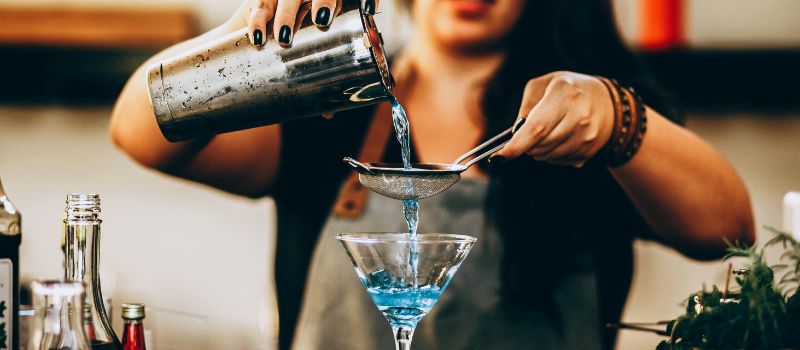 a bartender pouring some drink