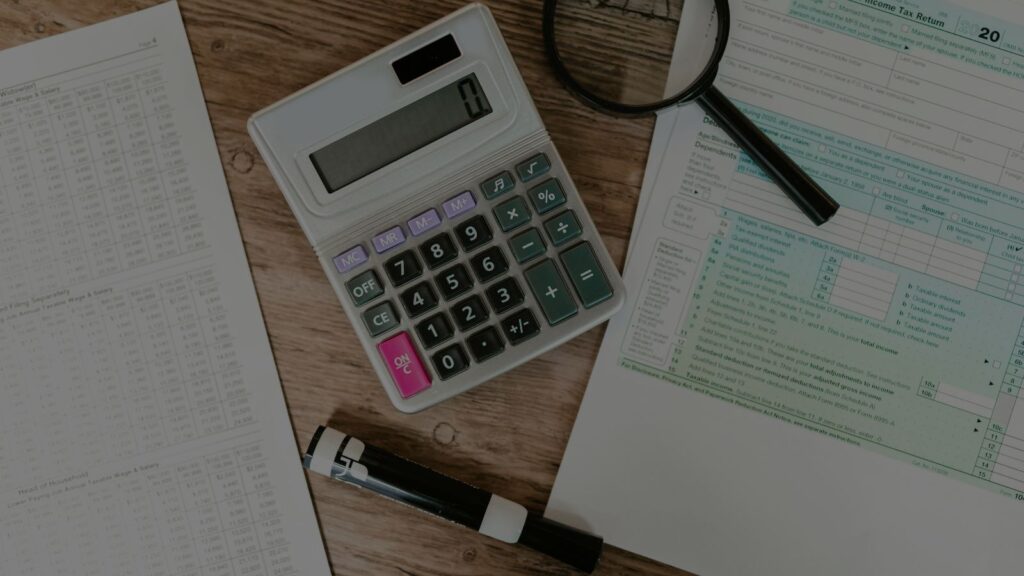 an image of a document, calculator, and a magnifying glass