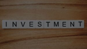 an image of blocks that has an investment write on it