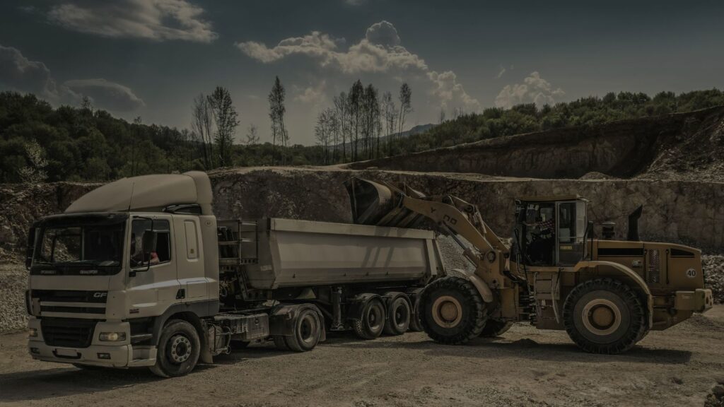 an image of a construction machinery and a truck
