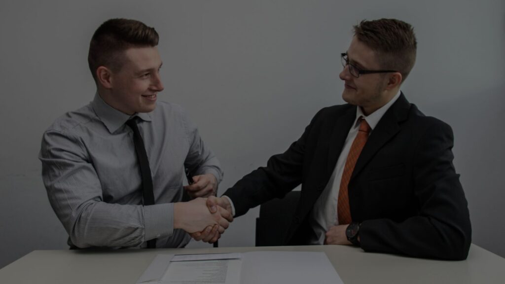an image of two people hand shaking