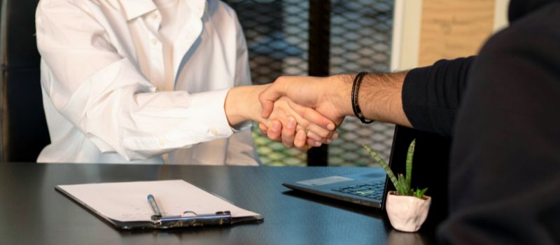 an image of two people hand shaking