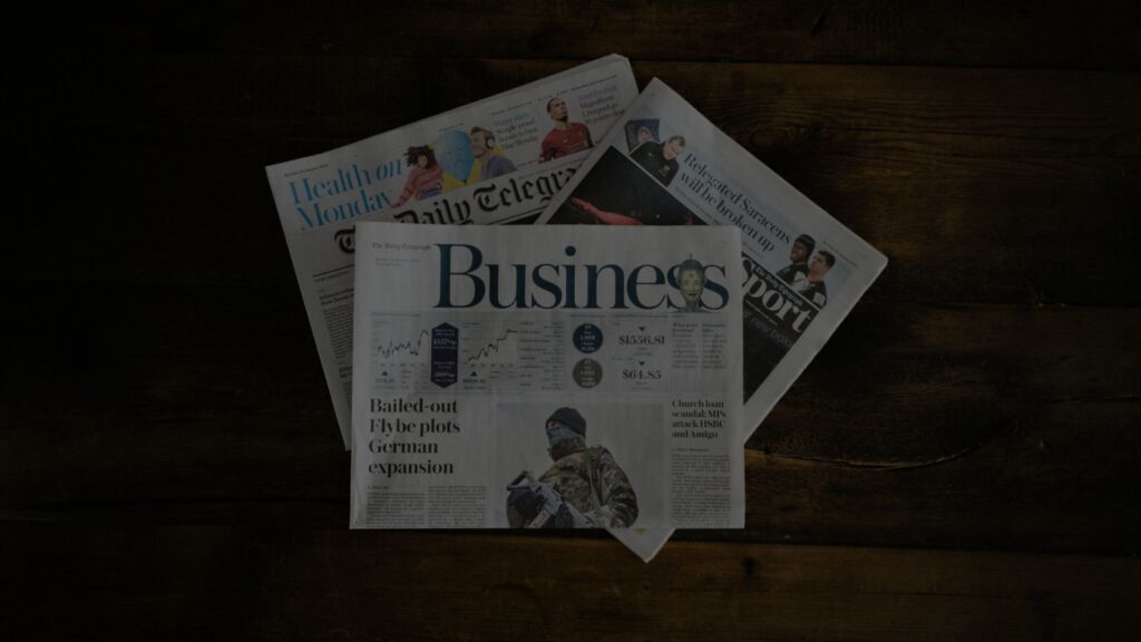an image of a newspaper that has a business written in the front page