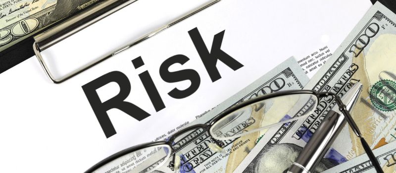 an image of risk written on a paper and a money with it