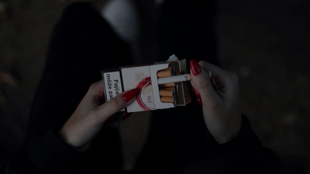 a woman holding a box of cigarette