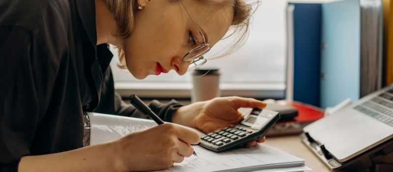 a woman carefully doing a calculation