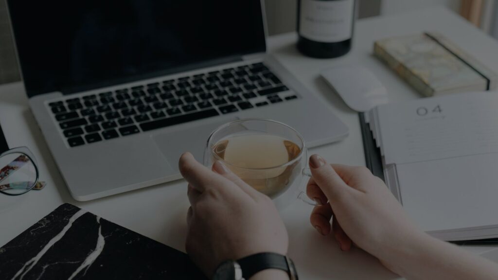 a person holding a cup of tea