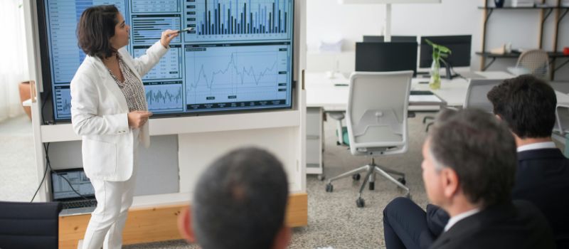 a person is reporting and showing some data