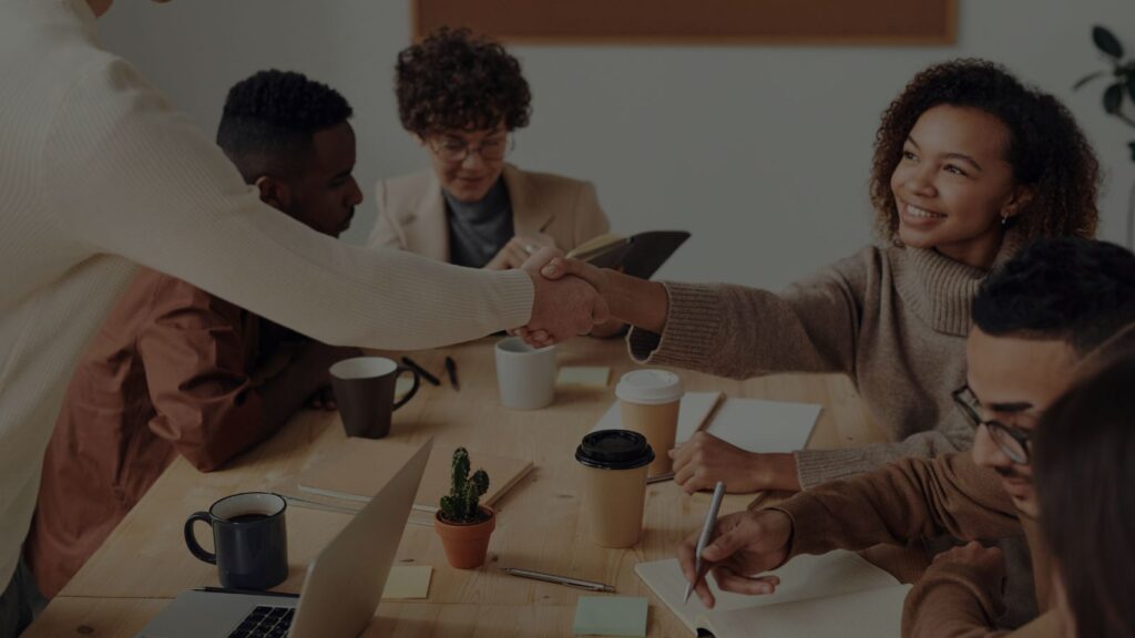 a group of people shaking hands at a table