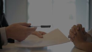 a person holding a pen and paper