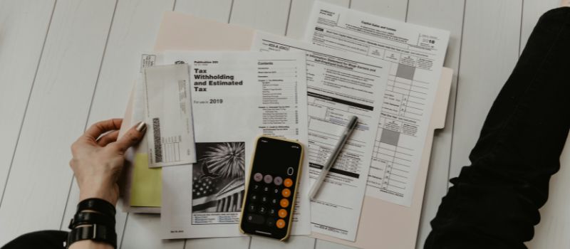 a calculator and pen on papers