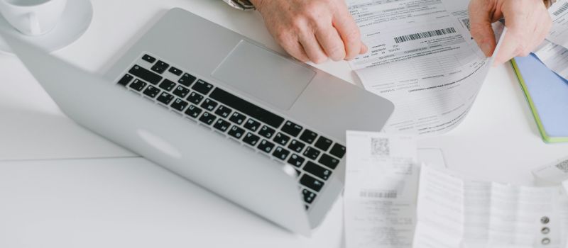 a laptop and files on the table