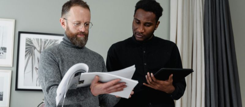 two person looking at the documents