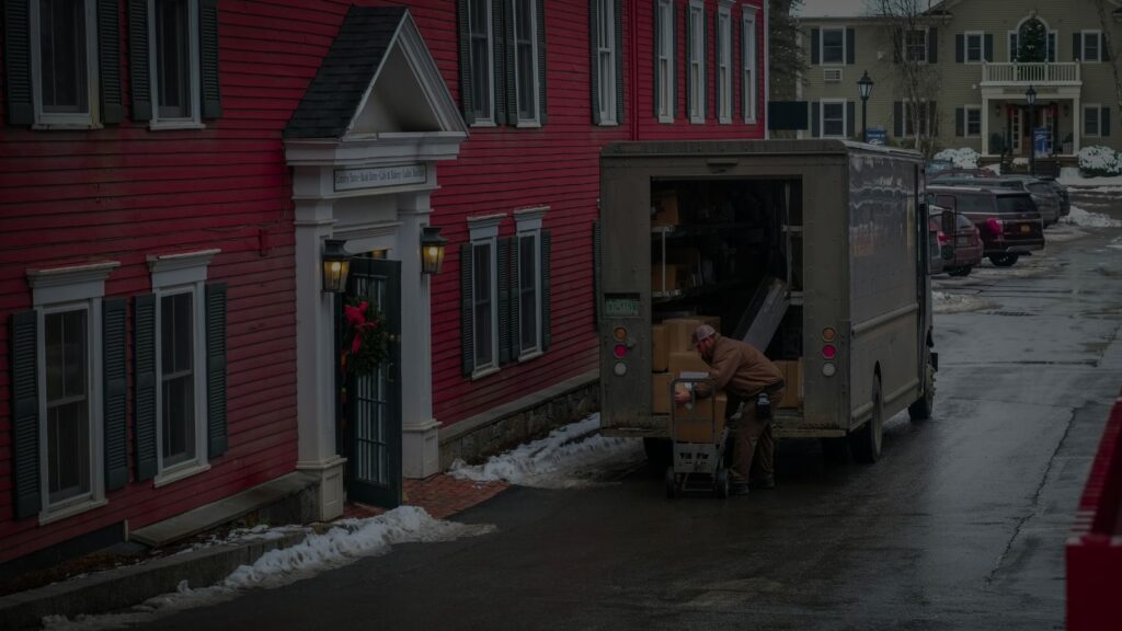 a moving truck in front of a new home