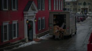 a moving truck in front of a new home