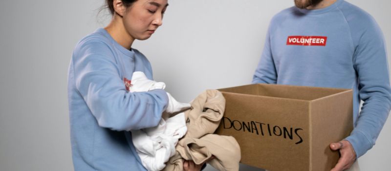 two volunteers giving some of their clothes