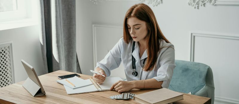 a physician writing her notebook