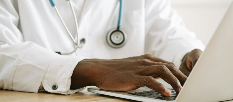 a physician working in the laptop