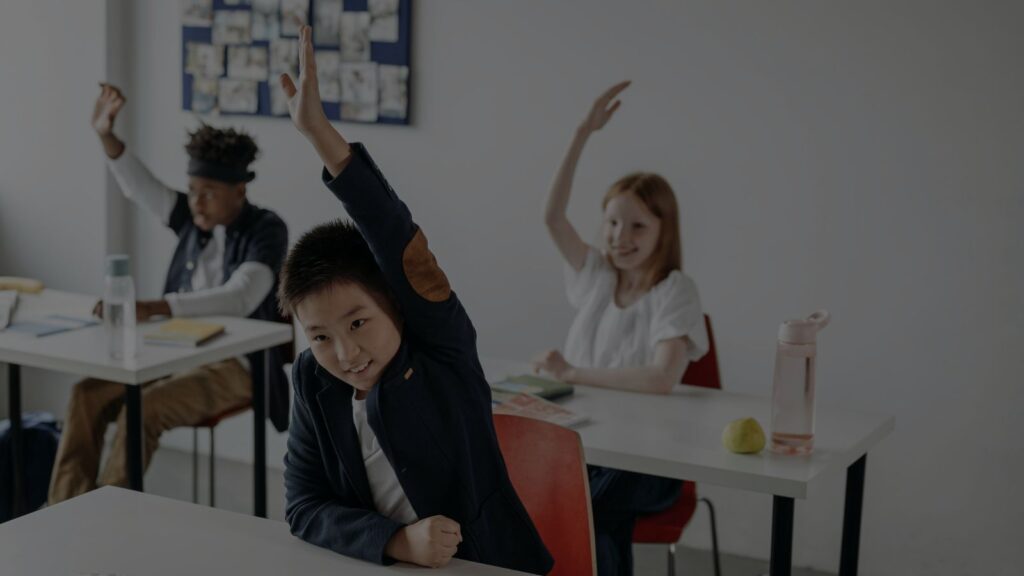 students raising their hands
