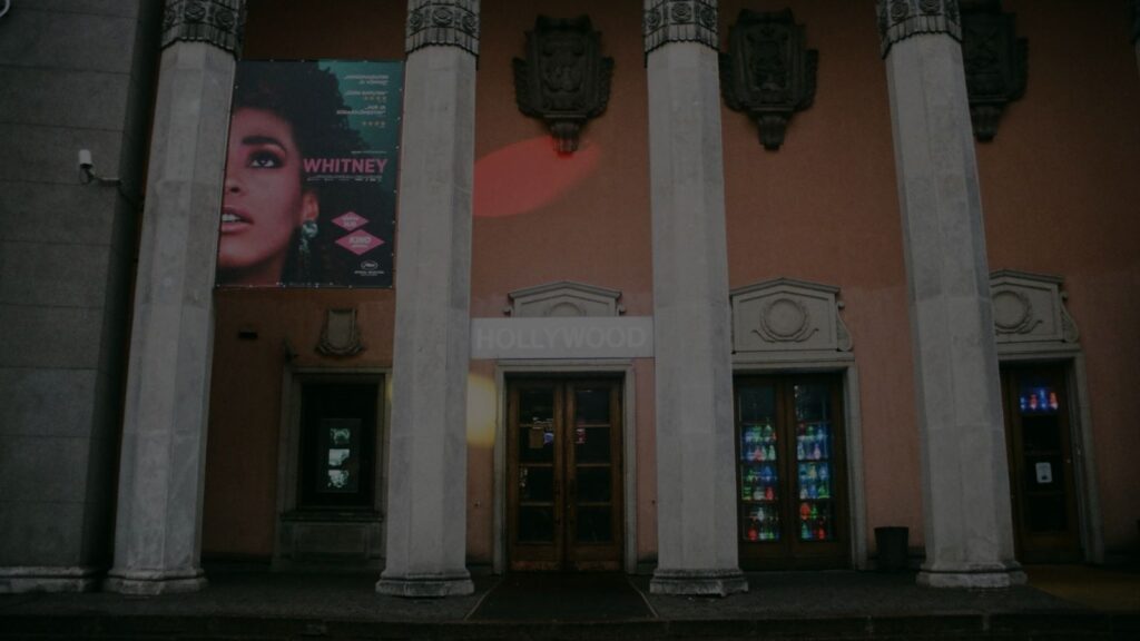 photo of whitney houston infront of a building