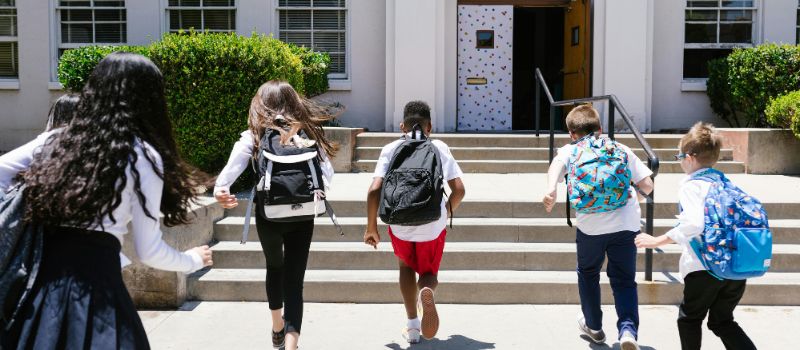 students running towards the building
