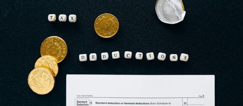 a paper a coin and a tax deductions word