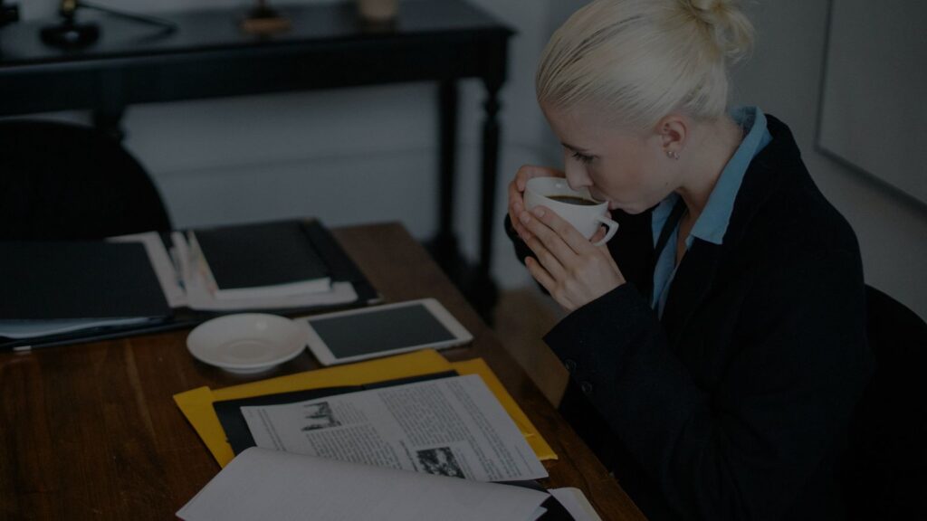 a person sipping her coffee